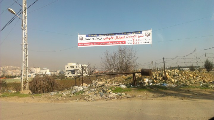 [Banner reads, among other things: "Gatherings of foreign workers are forbidden in public spaces. Image by author.]